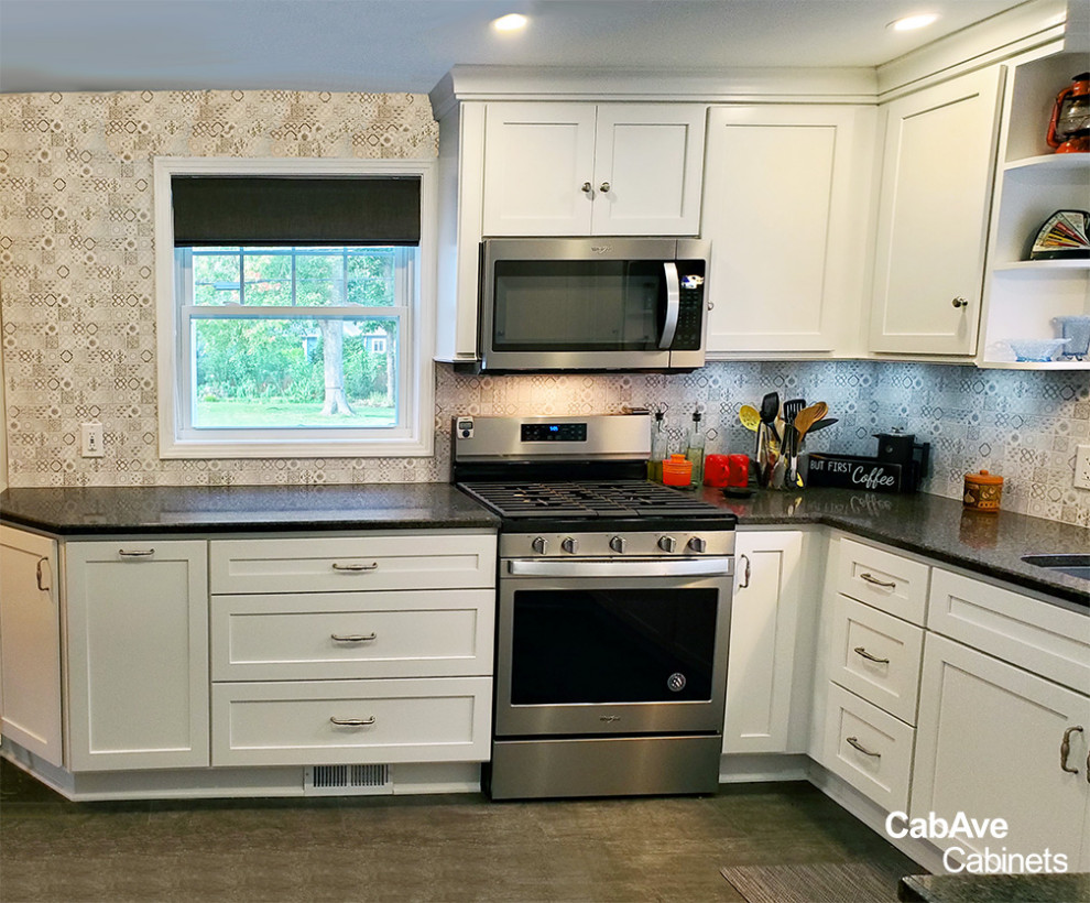 Eat-in kitchen - small transitional u-shaped dark wood floor and gray floor eat-in kitchen idea in New York with an undermount sink, shaker cabinets, white cabinets, granite countertops, multicolored backsplash, porcelain backsplash, stainless steel appliances, no island and black countertops