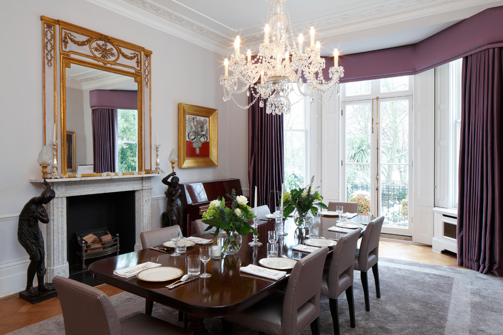 Inspiration for a traditional separate dining room in London with a standard fireplace.