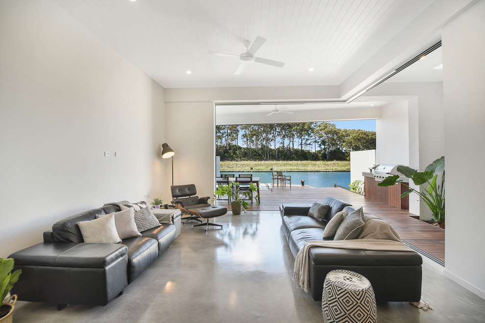 Inspiration for a contemporary open concept living room in Sunshine Coast with white walls, concrete floors and grey floor.
