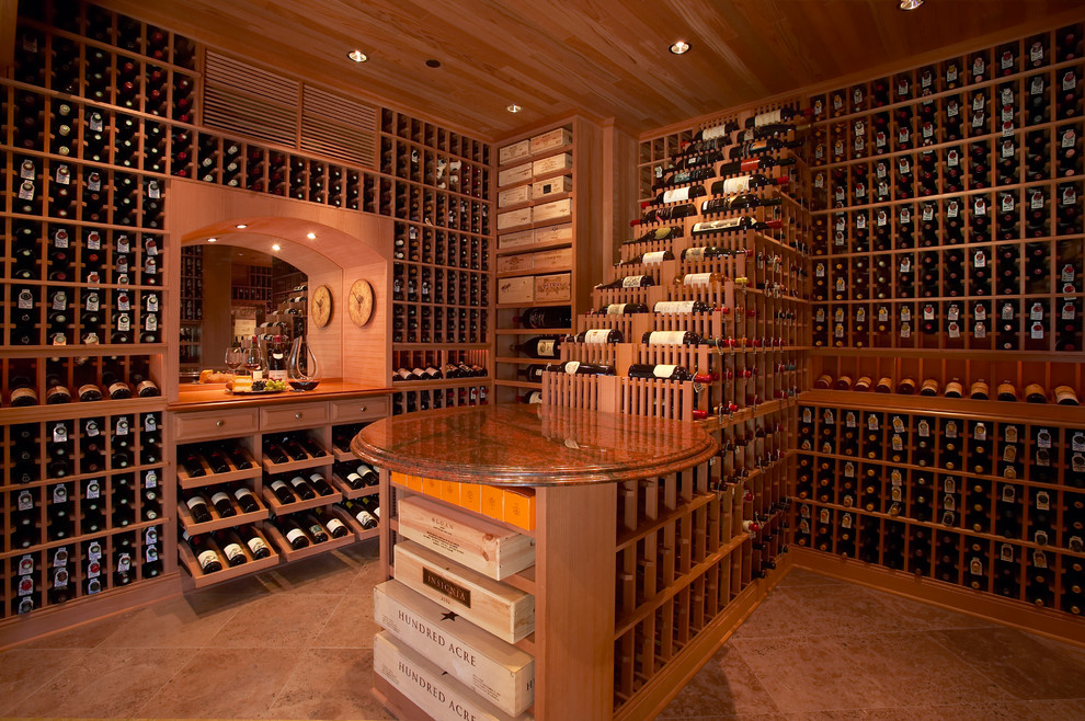 Photo of a large traditional wine cellar in Los Angeles with ceramic floors, display racks and orange floor.