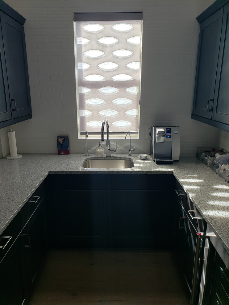 Inspiration for a mid-sized transitional kitchen pantry remodel in Phoenix with an undermount sink, shaker cabinets, dark wood cabinets, quartz countertops, stainless steel appliances, no island and white countertops