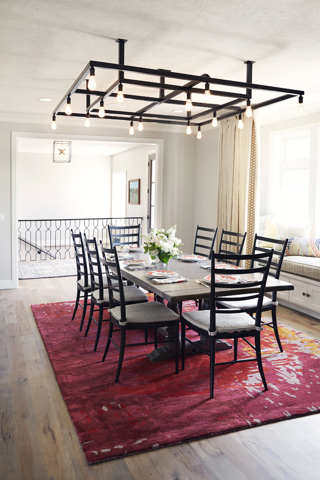 Inspiration for a large rustic medium tone wood floor great room remodel with white walls and a two-sided fireplace