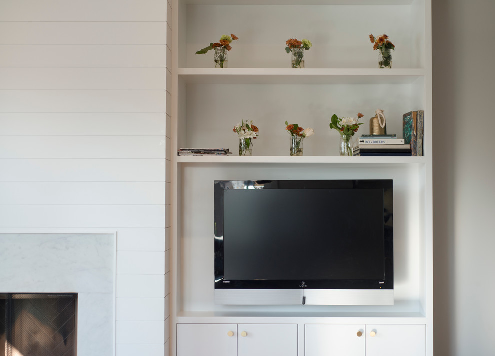 Family room - large scandinavian enclosed medium tone wood floor family room idea in New York with white walls, a standard fireplace, a stone fireplace and no tv