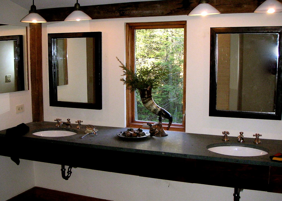 This is an example of a large country bathroom in New York with a drop-in sink, flat-panel cabinets, dark wood cabinets, an alcove tub, a two-piece toilet, white tile, ceramic tile, white walls, light hardwood floors, granite benchtops and with a sauna.