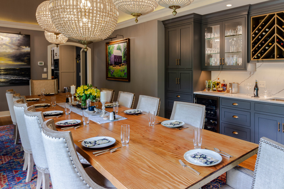 Inspiration for a large transitional medium tone wood floor, brown floor and exposed beam enclosed dining room remodel with gray walls