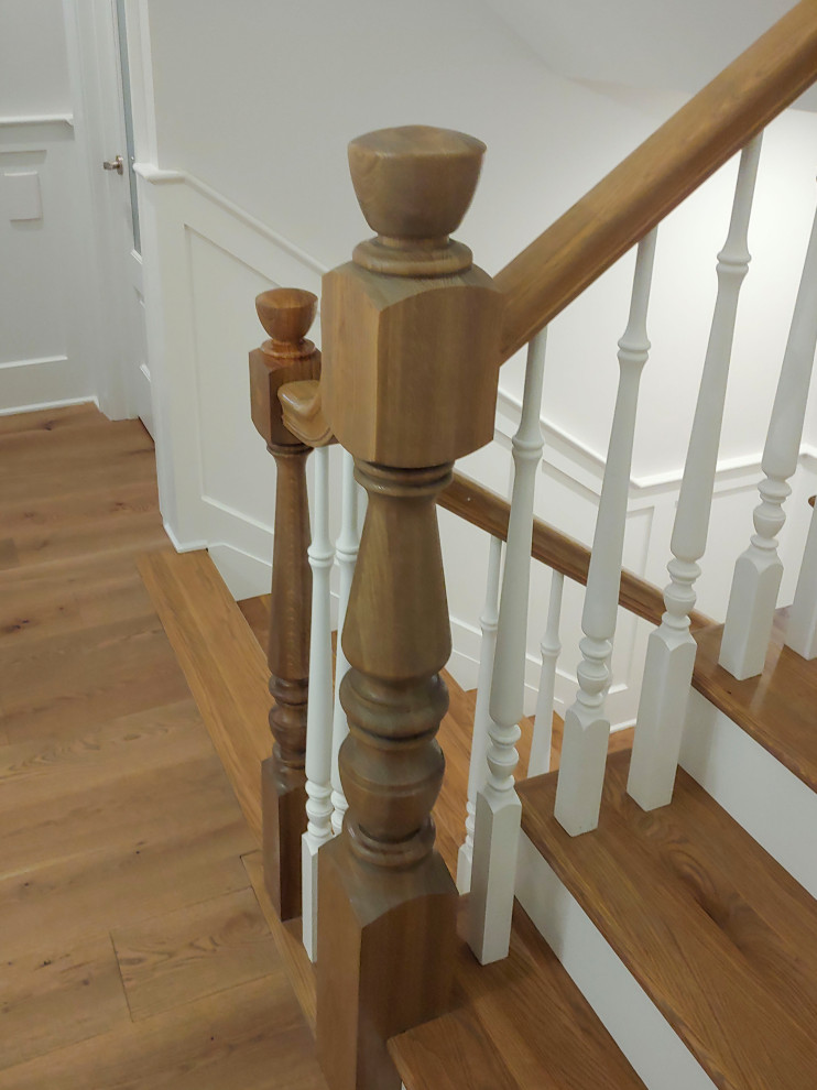 Design ideas for a medium sized traditional wood u-shaped wood railing staircase in DC Metro with painted wood risers and wainscoting.