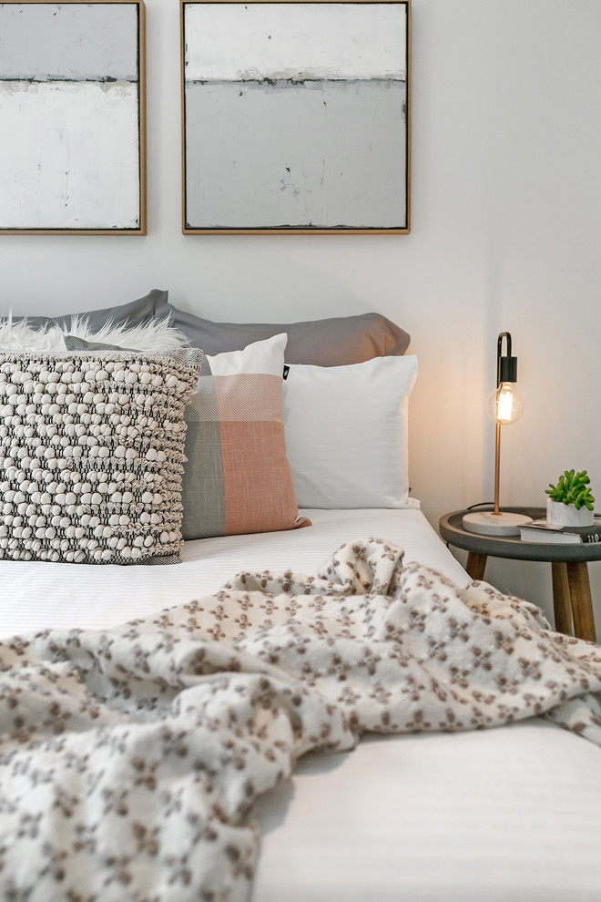 Contemporary master bedroom in Hobart with white walls.