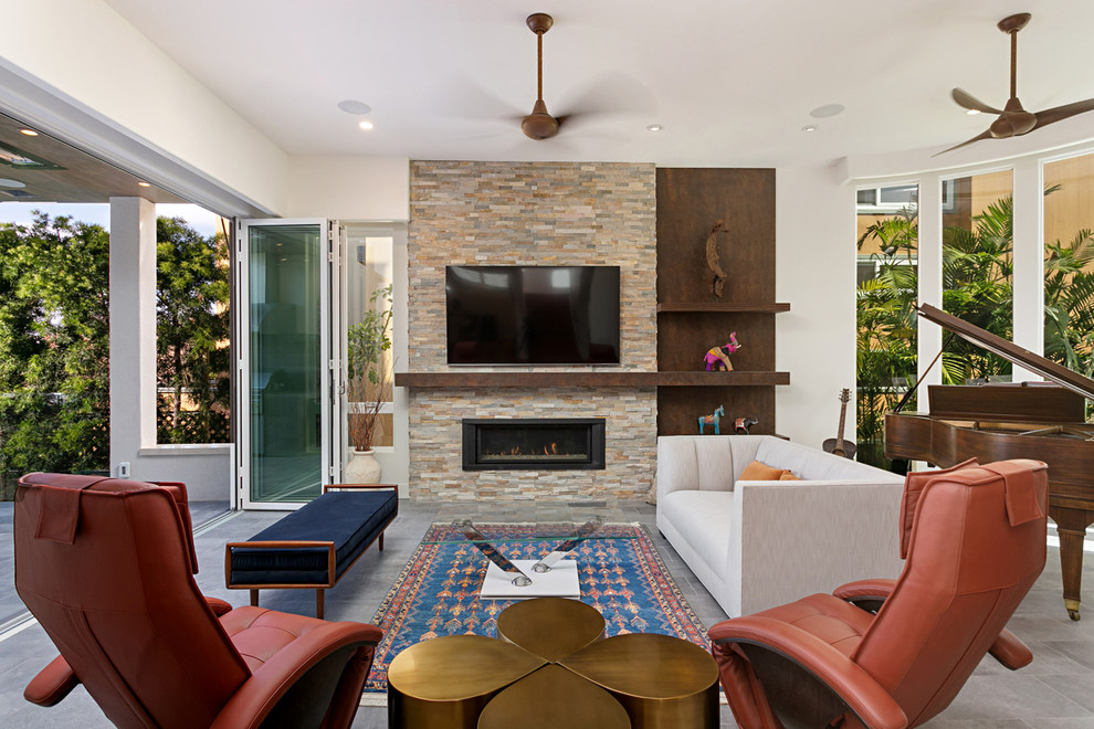 Living room library - mid-sized transitional enclosed gray floor and porcelain tile living room library idea in San Diego with white walls, a wall-mounted tv, a ribbon fireplace and a stone fireplace