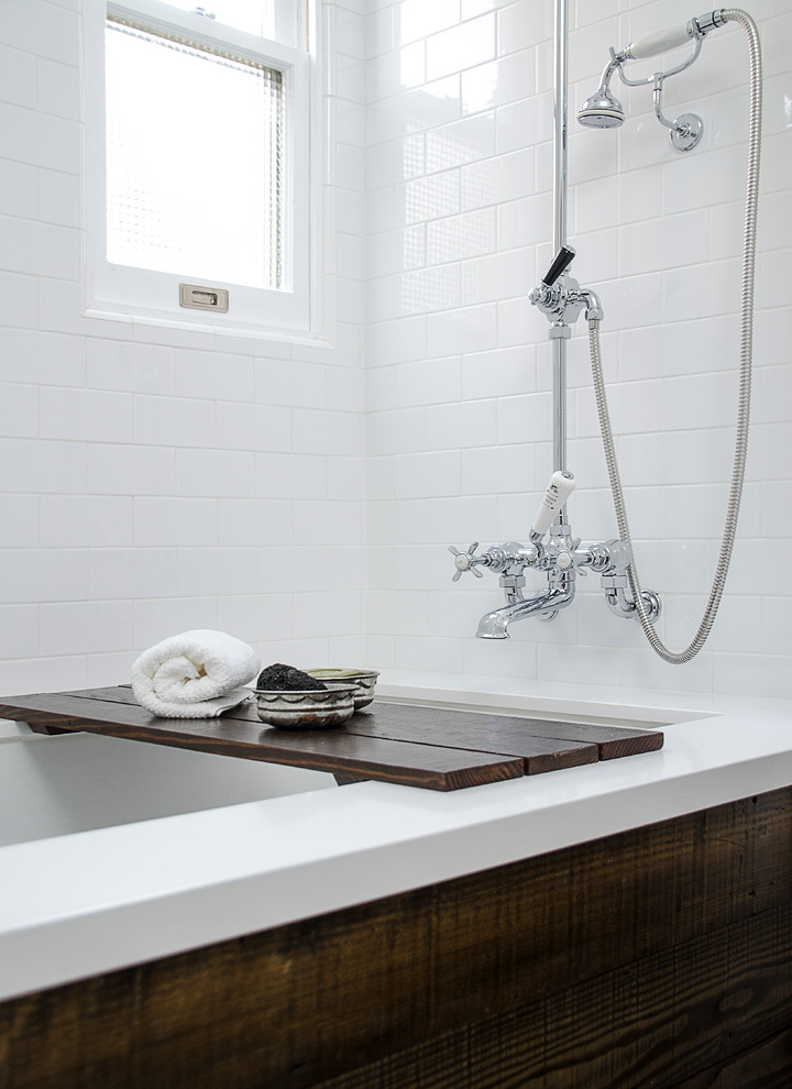 Inspiration for a small transitional master white tile and subway tile marble floor tub/shower combo remodel in Los Angeles with an undermount tub, a two-piece toilet, white walls, a drop-in sink, solid surface countertops and flat-panel cabinets