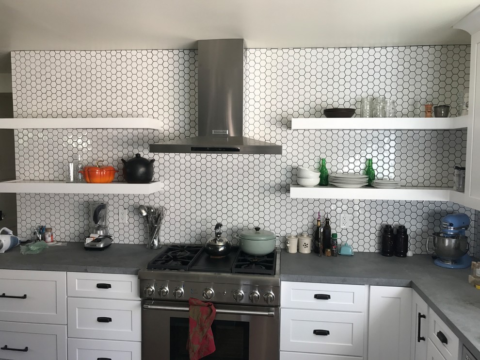This is an example of a large modern single-wall eat-in kitchen in Los Angeles with an undermount sink, shaker cabinets, white cabinets, tile benchtops, multi-coloured splashback, ceramic splashback, stainless steel appliances, with island and grey benchtop.