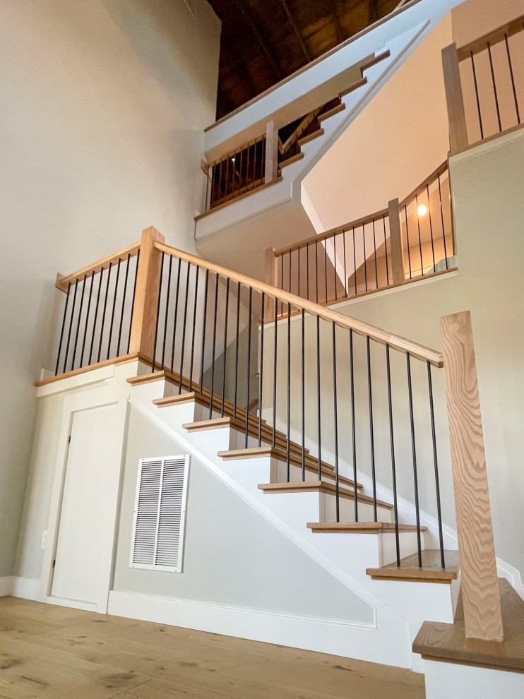 This is an example of an expansive transitional wood straight staircase in DC Metro with wood risers and mixed railing.