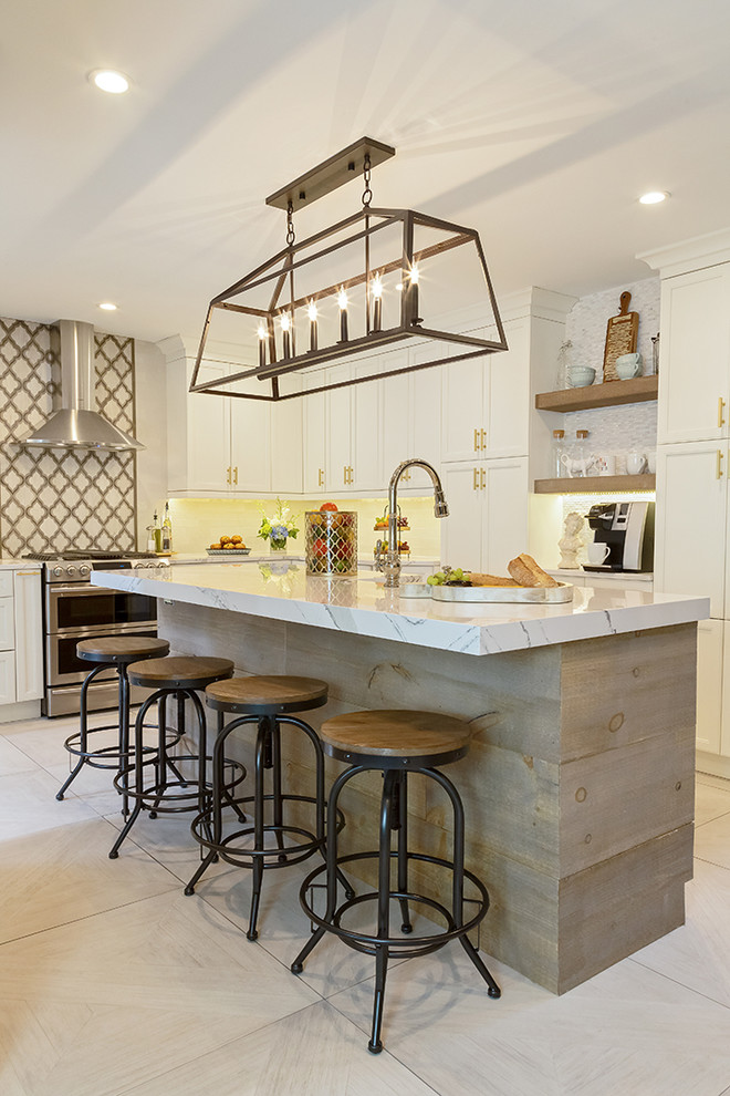 Photo of a large country eat-in kitchen in New York with a farmhouse sink, beaded inset cabinets, white cabinets, quartz benchtops, beige splashback, stone tile splashback, stainless steel appliances, porcelain floors and with island.