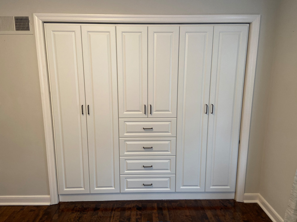 Inspiration for a storage and wardrobe in Minneapolis with white cabinets.