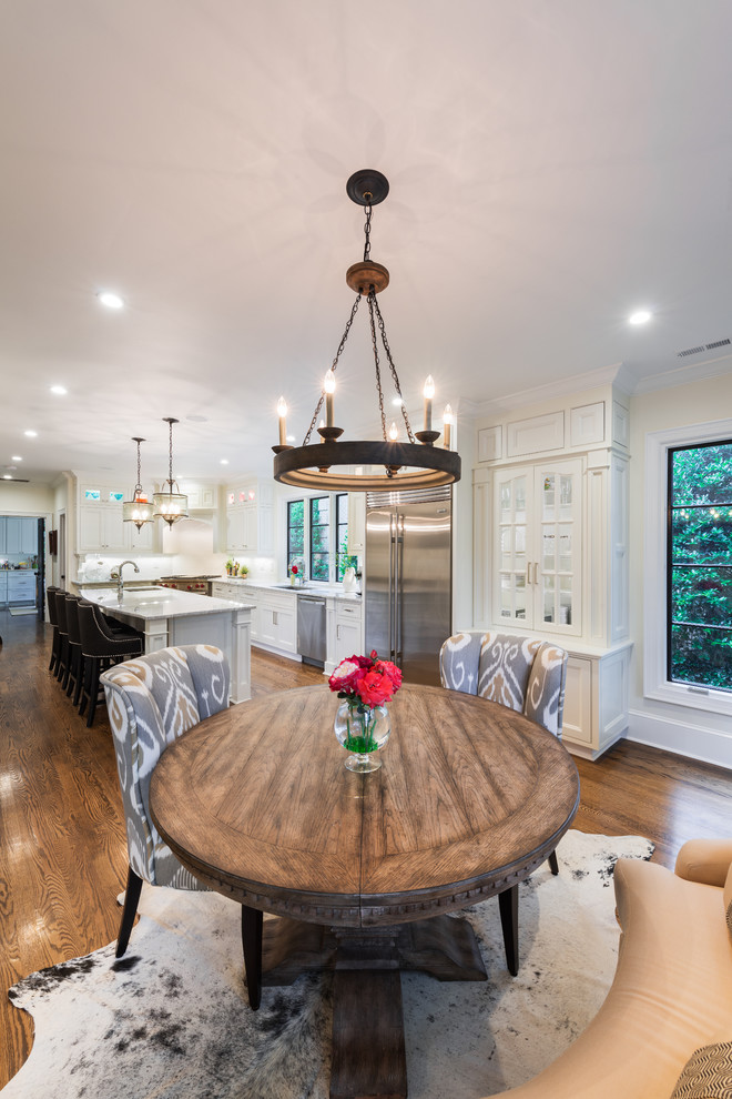 Inspiration for a traditional kitchen/dining combo in Charlotte with beige walls and dark hardwood floors.