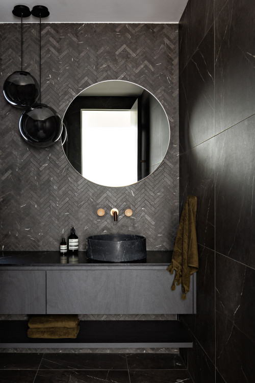 Modern Monochrome: All-Black Bathroom with Herringbone Tile Backsplash