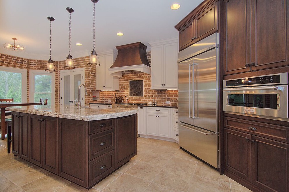 Inspiration for a mid-sized rustic l-shaped travertine floor and beige floor eat-in kitchen remodel in Charlotte with a farmhouse sink, beaded inset cabinets, white cabinets, granite countertops, red backsplash, brick backsplash, stainless steel appliances and an island