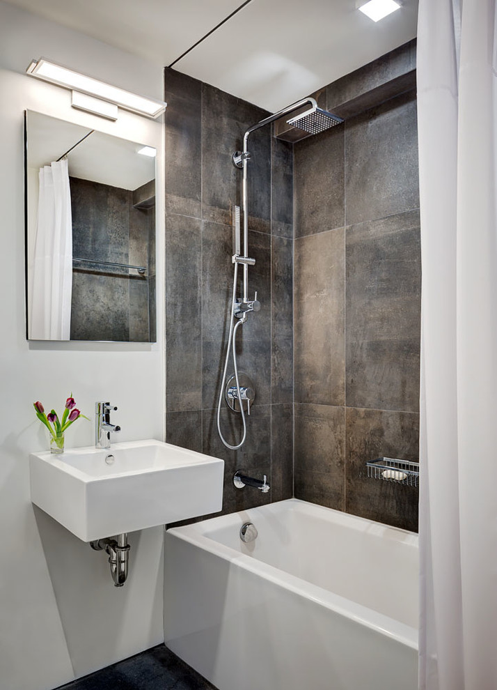 Inspiration for a mid-sized modern bathroom in New York with a shower/bathtub combo, white walls and a wall-mount sink.