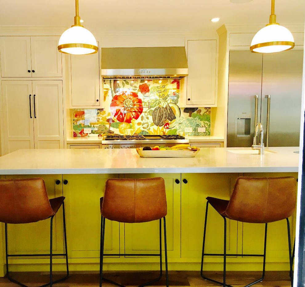 Inspiration for a large country l-shaped eat-in kitchen in San Francisco with a farmhouse sink, multi-coloured splashback, glass sheet splashback, stainless steel appliances, with island, brown floor, medium hardwood floors, shaker cabinets, white cabinets and quartzite benchtops.