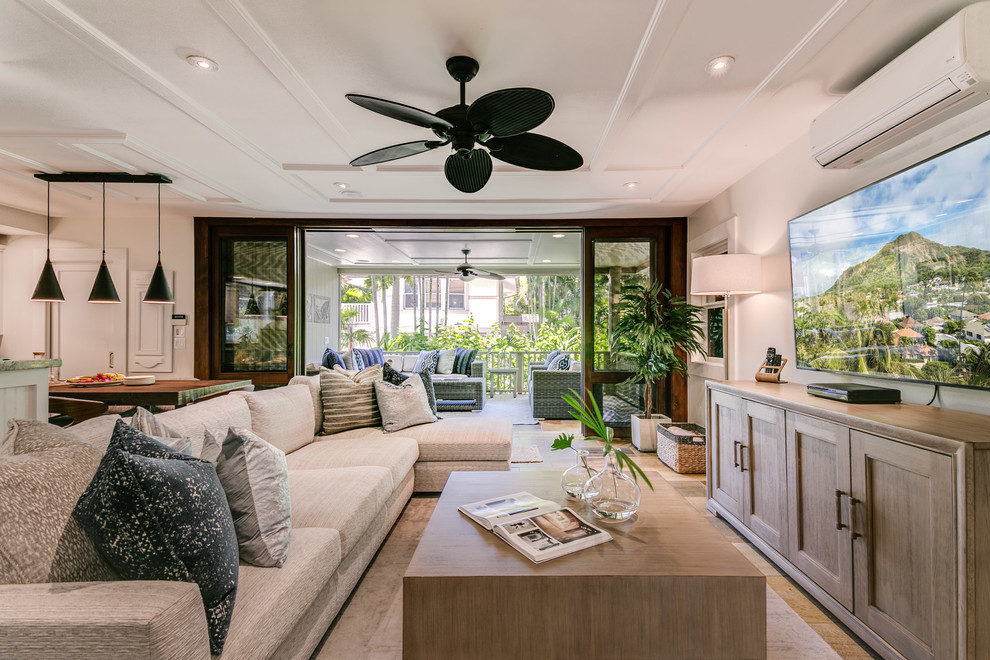 This is an example of a mid-sized beach style open concept living room in Hawaii with beige walls, no fireplace, a wall-mounted tv and multi-coloured floor.