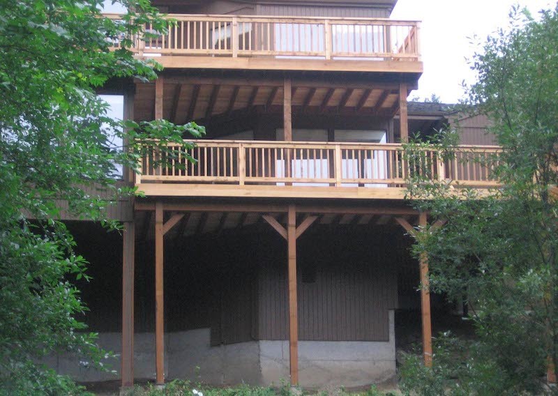 Inspiration for a mid-sized backyard balcony deck remodel in Seattle with a roof extension