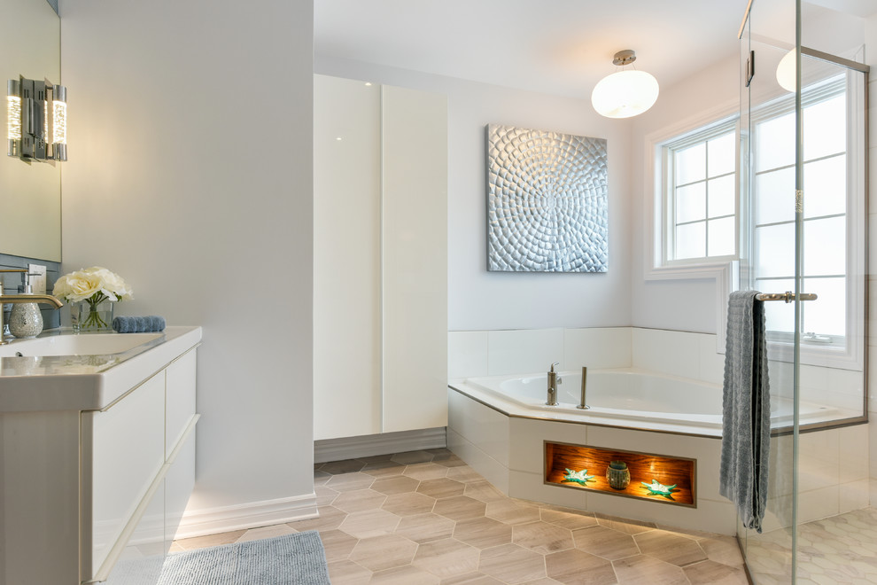 Photo of a large contemporary kids bathroom in Montreal with flat-panel cabinets, white cabinets, a corner tub, a curbless shower, a wall-mount toilet, blue tile, ceramic tile, blue walls, porcelain floors, an integrated sink and solid surface benchtops.