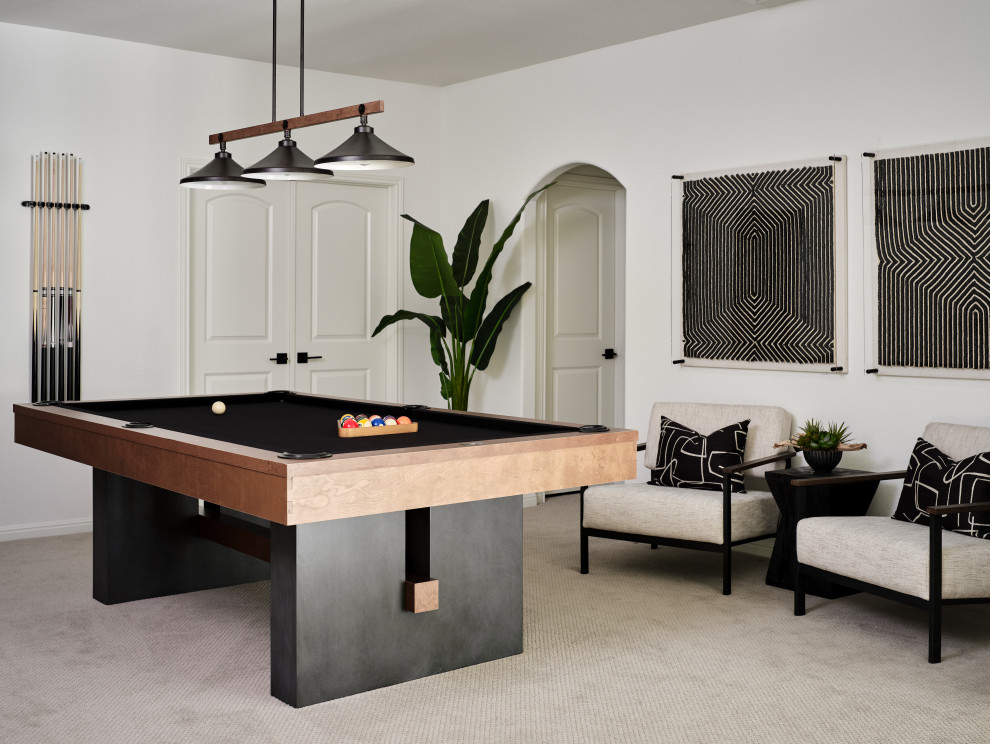 Belterra Project- Furnishings, Lighting Fixtures & Interior Design - This sophisticated game room provides hours of play for a young and active family.  The black, white and beige color scheme adds a masculine touch.  Wood and iron accents are repeated throughout the room in the armchairs, pool table, pool table light fixture and in the custom built in bar counter.  This pool table also accommodates a ping pong table top, as well, which is a great option when space doesn't permit a separate pool table and ping pong table.  Since this game room loft area overlooks the home's foyer and formal living room, the modern color scheme unites the spaces and provides continuity of design.  A custom white oak bar counter and iron barstools finish the space and create a comfortable hangout spot for watching a friendly game of pool.