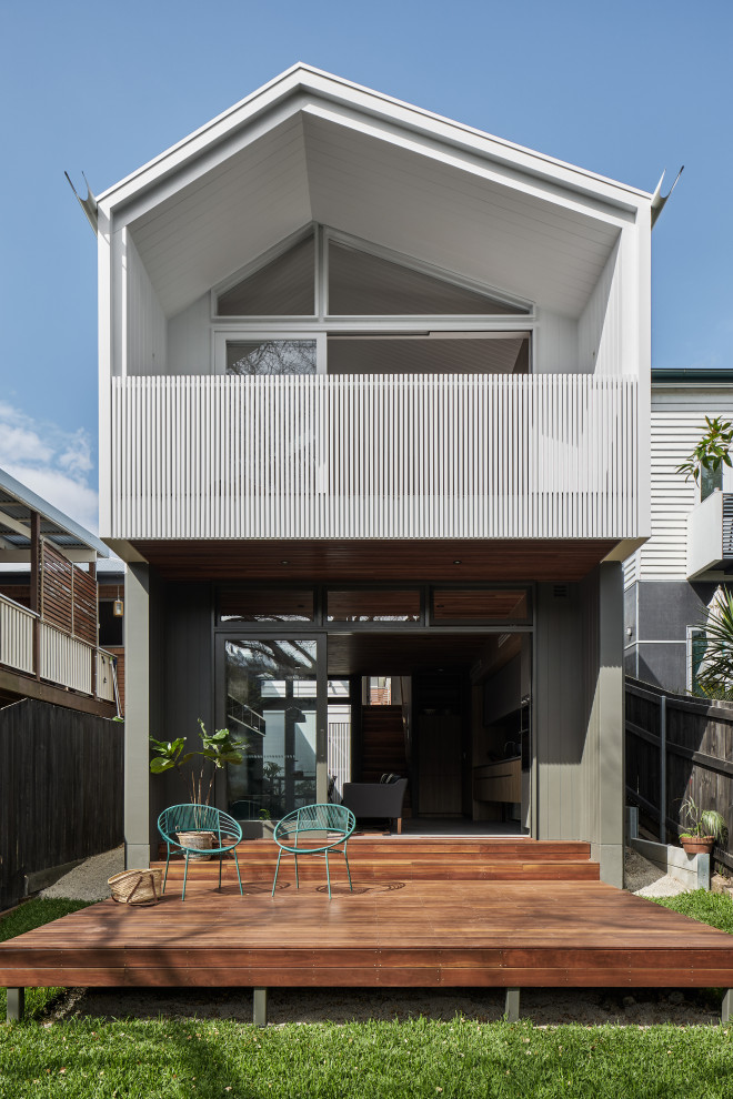 Photo of a mid-sized contemporary split-level white house exterior in Brisbane with concrete fiberboard siding, a metal roof, a grey roof and board and batten siding.