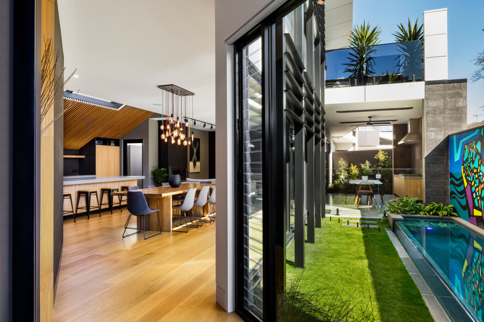 Design ideas for a mid-sized modern backyard partial sun formal garden for spring in Melbourne.