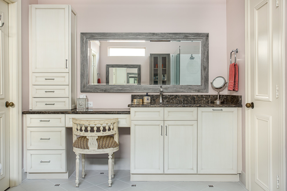 Design ideas for a large master bathroom in Dallas with flat-panel cabinets, beige cabinets, a freestanding tub, an open shower, a two-piece toilet, white tile, ceramic tile, pink walls, porcelain floors, an undermount sink, engineered quartz benchtops, white floor and a hinged shower door.