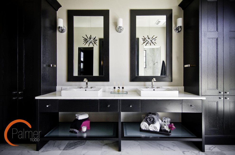 This is an example of a modern bathroom in Austin with black cabinets.