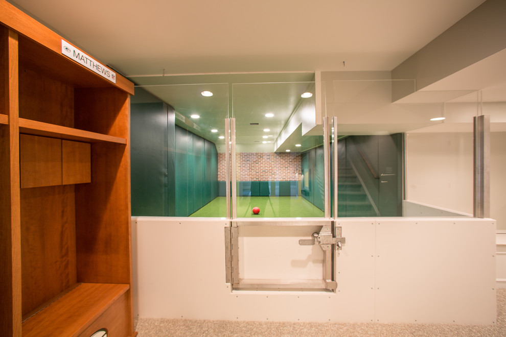 Large modern fully buried basement in Philadelphia with green walls, carpet and no fireplace.