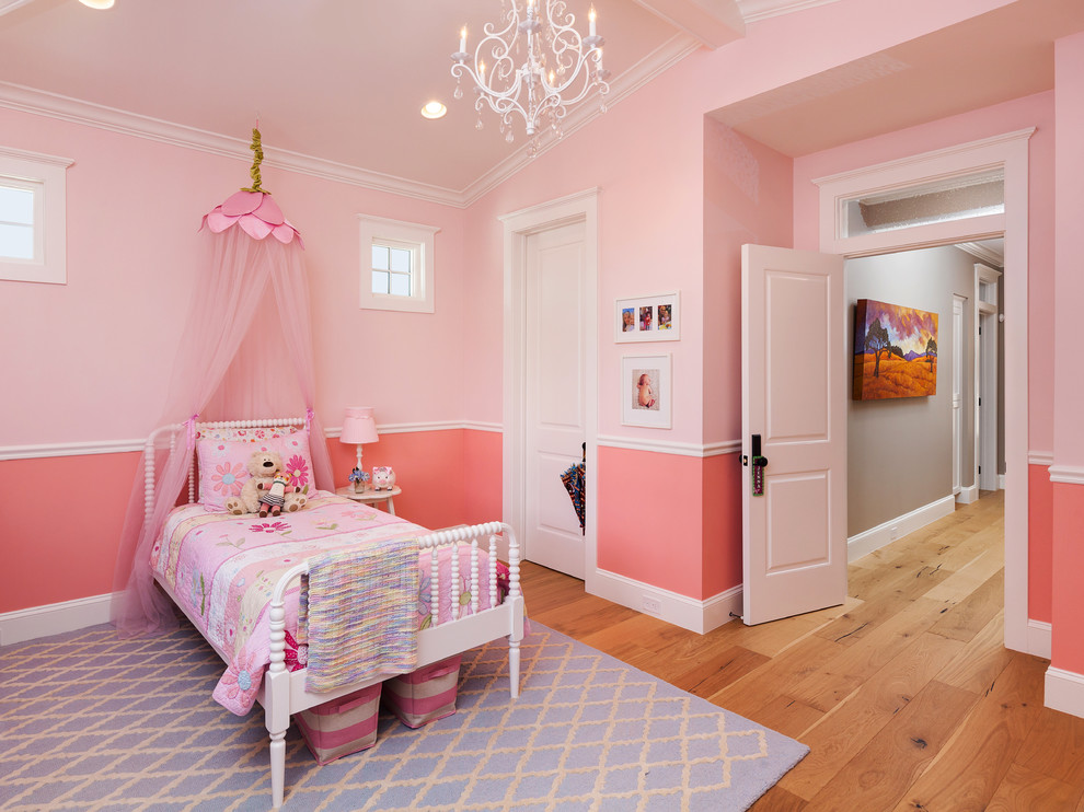 Design ideas for a traditional kids' room for girls in Phoenix with pink walls and light hardwood floors.