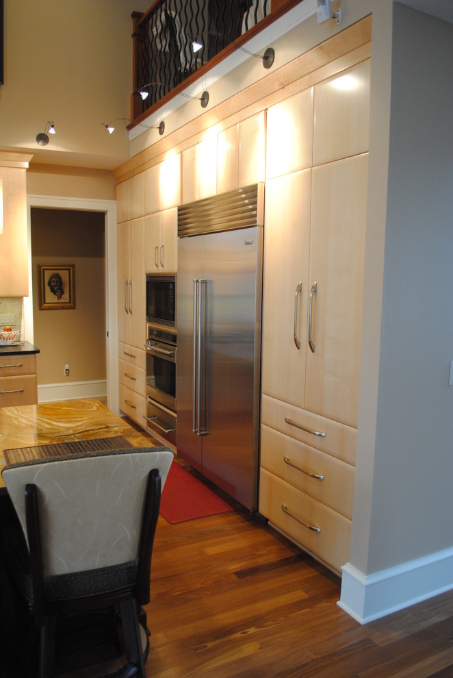 Example of a l-shaped enclosed kitchen design in Cleveland with flat-panel cabinets, light wood cabinets and an island