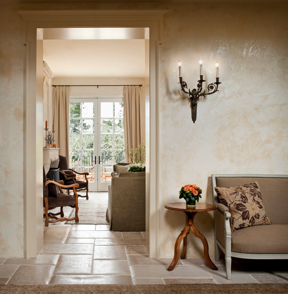 This is an example of a mid-sized mediterranean entry hall in Other with beige walls, travertine floors, a single front door and a white front door.