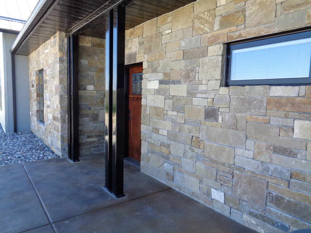This is an example of a mid-sized modern front door in Other with a single front door, a medium wood front door and concrete floors.