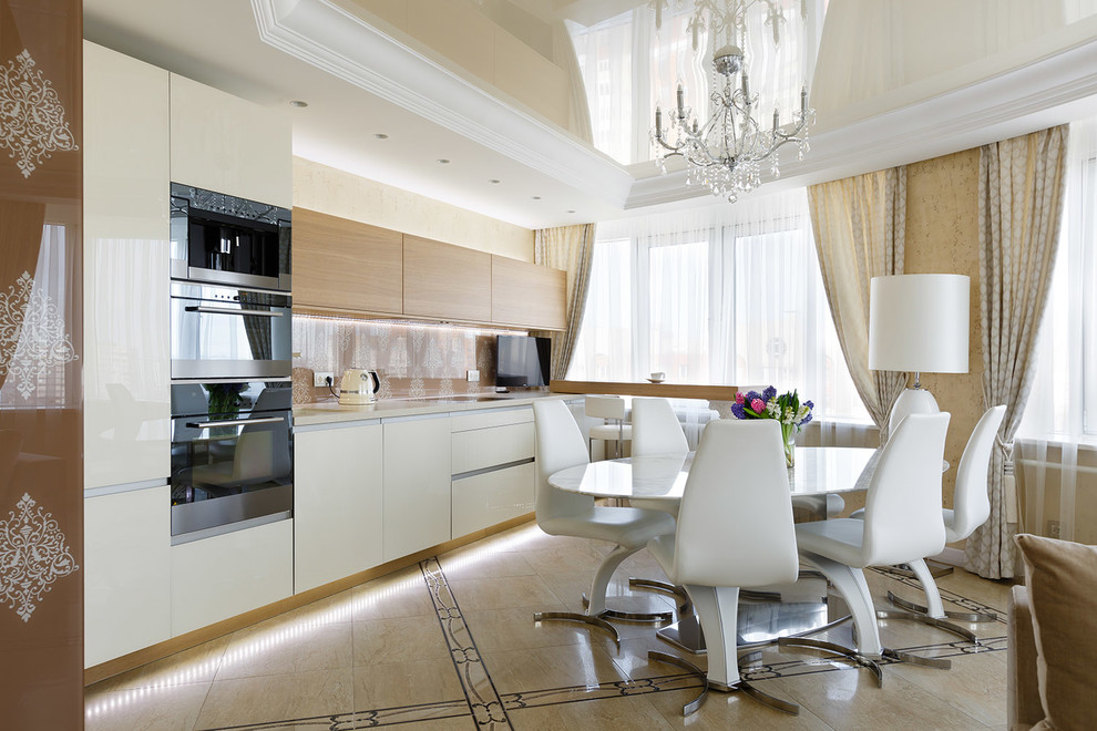 Photo of a mid-sized contemporary single-wall open plan kitchen in Saint Petersburg with flat-panel cabinets, white cabinets, beige splashback, black appliances, a peninsula, an undermount sink, solid surface benchtops, glass sheet splashback, ceramic floors, multi-coloured floor and beige benchtop.