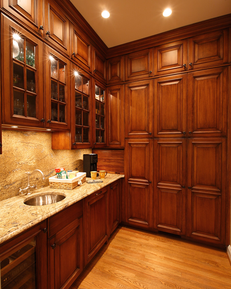 Traditional kitchen in Other with glass-front cabinets.