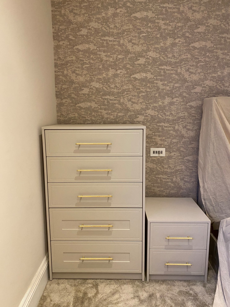 Photo of a large traditional storage and wardrobe in Other with shaker cabinets, beige cabinets, medium hardwood floors and yellow floor.