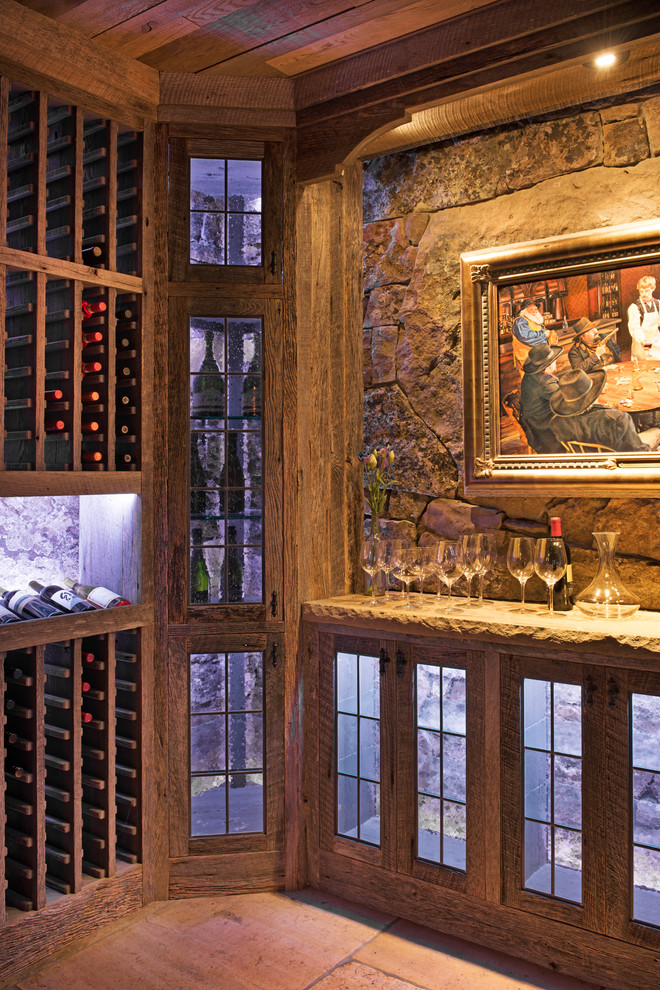 Inspiration for a large country wine cellar in Other with travertine floors and display racks.