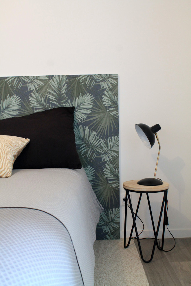 This is an example of a small tropical bedroom in Other with white walls.
