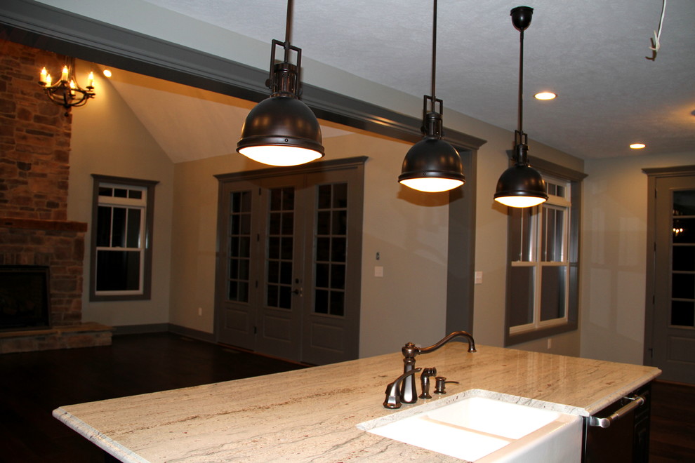 Inspiration for a large rustic single-wall open concept kitchen remodel with an island, granite countertops, a farmhouse sink, stainless steel appliances, shaker cabinets and gray cabinets