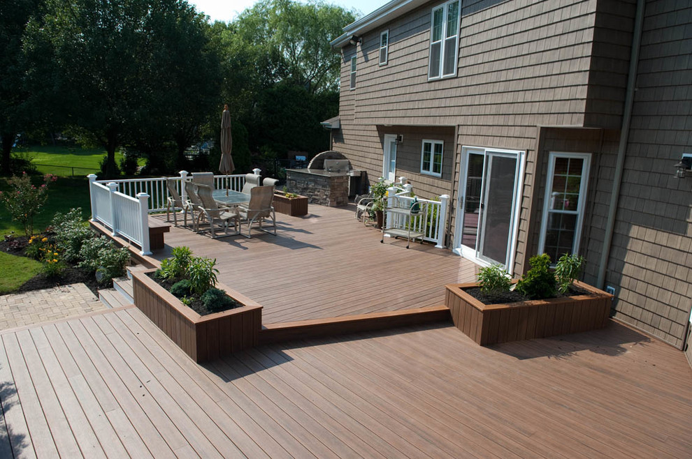 Inspiration for a large transitional backyard outdoor kitchen deck remodel in New York with no cover