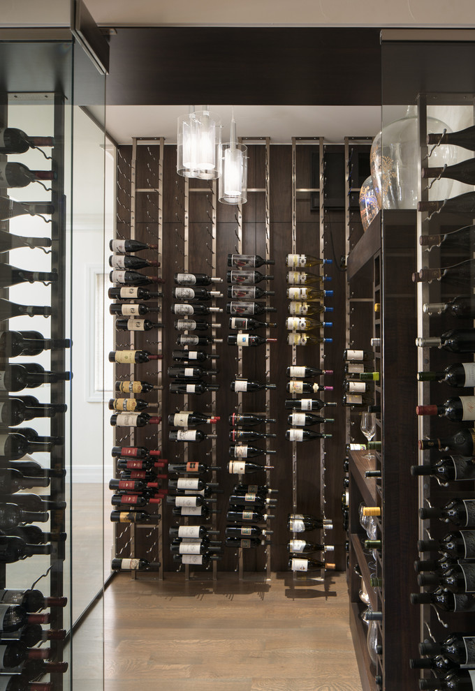 Design ideas for a transitional wine cellar in Denver with light hardwood floors, display racks and beige floor.