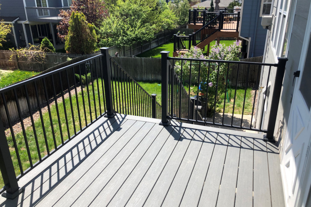 Deck - mid-sized backyard second story metal railing deck idea with no cover