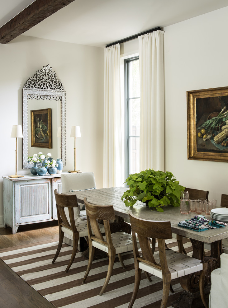 This is an example of a mid-sized traditional open plan dining in Dallas with white walls, dark hardwood floors, no fireplace and brown floor.