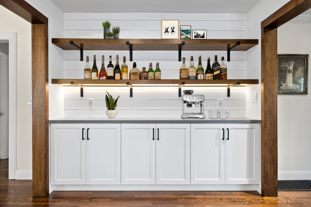 Photo of a home bar in Los Angeles with shaker cabinets, white cabinets, quartz benchtops, white splashback, shiplap splashback, dark hardwood floors and grey benchtop.
