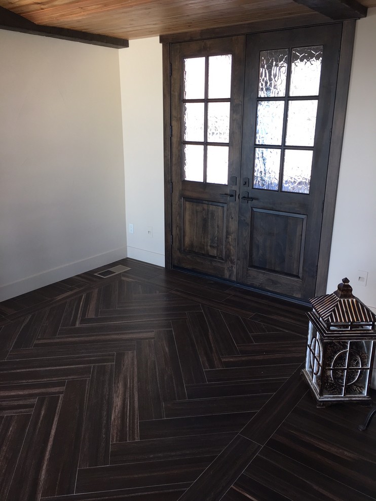Home design - large rustic open concept porcelain tile home design idea with beige walls