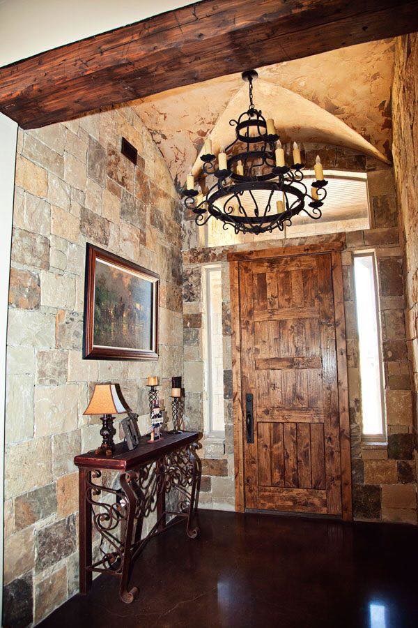 Example of a small mountain style concrete floor and brown floor front door design in Austin with gray walls and a medium wood front door