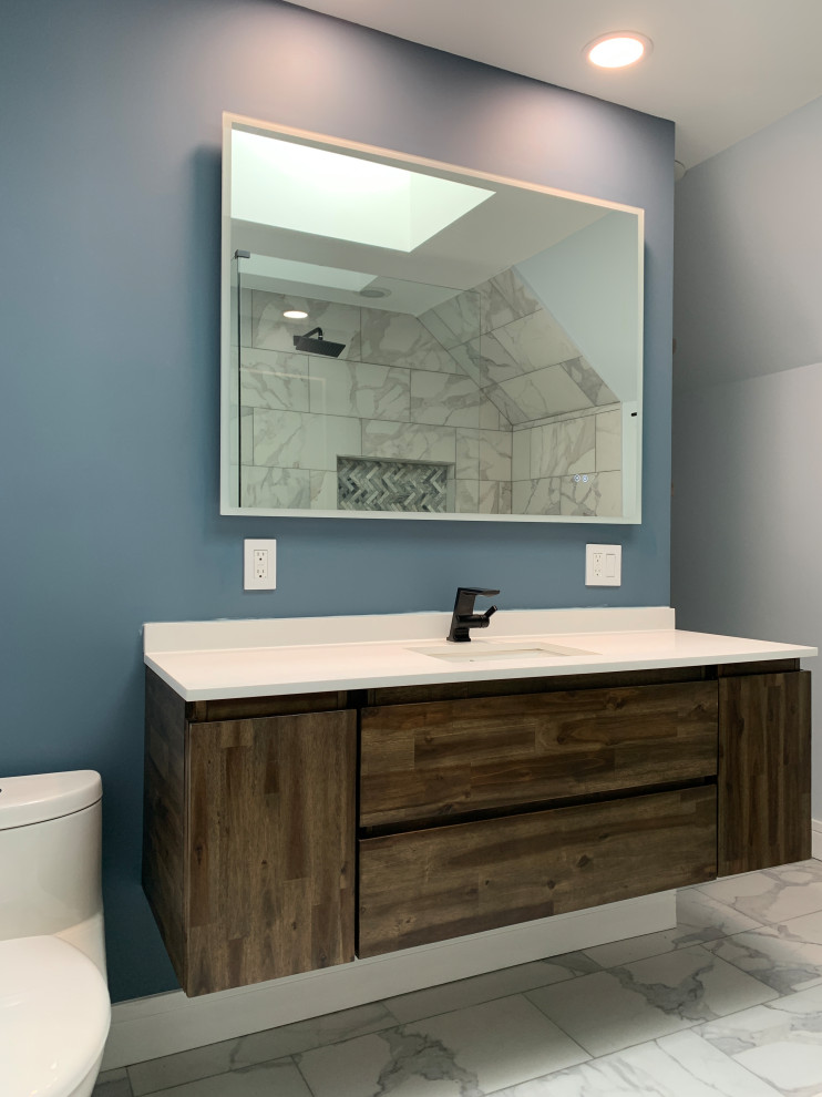 Photo of a medium sized traditional ensuite bathroom in Chicago with flat-panel cabinets, brown cabinets, a walk-in shower, a one-piece toilet, white tiles, porcelain tiles, blue walls, porcelain flooring, a built-in sink, quartz worktops, white floors, an open shower, white worktops, a single sink and a floating vanity unit.