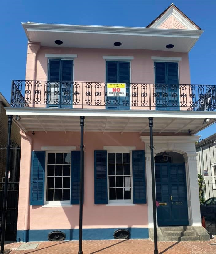 This is an example of a two-storey pink exterior in New Orleans with wood siding.
